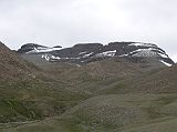 Tibet Kailash 09 Kora 15 Kailash Eastern Face in Clouds About 30 minutes from the end of the descent from the Dolma La, a valley comes down from the Khando Sanglam La to join the main trail. This valley provides the only glimpse of Kailash�s eastern or crystal face � alas again in the clouds.